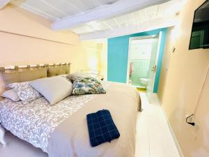 a bedroom with a bed and a bathroom at Casa Tonia San Cesareo in Sorrento