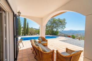 a villa with a view of a swimming pool at Casa Hyam in Alcaucín