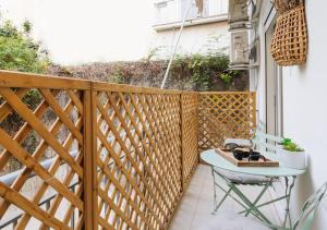 a small balcony with a table on a wooden deck at A place 4 U No19 in Athens