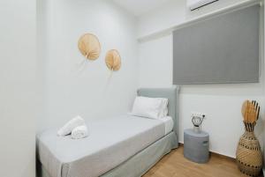 a white room with a bed and a tv at A place 4 U No19 in Athens