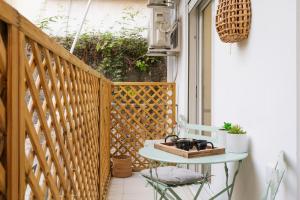 a small balcony with a table on a wooden railing at A place 4 U No19 in Athens