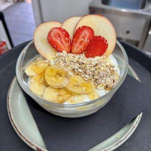 a bowl of fruit with bananas and strawberries on a table at Holiday Club Puerto Calma in Puerto Rico de Gran Canaria