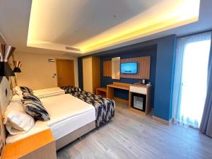 a hotel room with two beds and a television at Downtown Sirkeci Hotel in Istanbul
