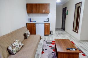 a living room with a couch and a table at City Hall Apart Hotel in Istanbul