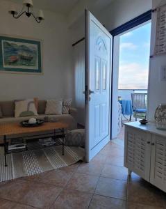 sala de estar con puerta que da a una habitación con sofá en Ocean Vista Retreat, en Skála