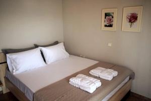 a bedroom with a bed with two towels on it at Ocean Vista Retreat in Skála