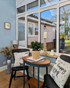 a room with a table and two chairs and a window at Firs End - Close to Norfolk Broads and Coast - Crabpot Cottages Sheringham in North Walsham
