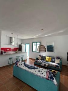 a living room with two couches and a kitchen at Villa Turquesa in Zahora
