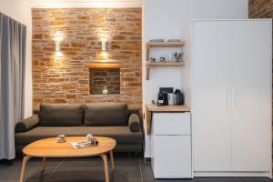 a living room with a couch and a table at White and black Suites Triple in Sifnos