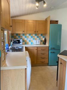 A kitchen or kitchenette at Walled Garden Lodges Loch Lomond