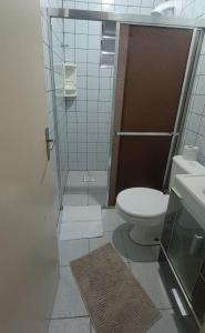 a small bathroom with a toilet and a sink at Casa de Praia Extremo Sul in Rio Grande