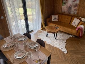 a living room with two tables and a couch at Cichy Brzyzek in Biały Dunajec +14 photos