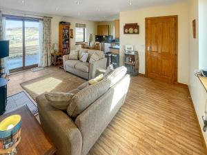 a living room with a couch and a table at The Barn in Lairg