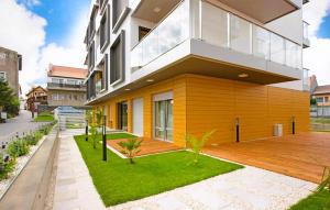 a large house with a wooden deck in front of it at 2 Bedroom Gorgeous Apartment In Hel in Hel +6 photos