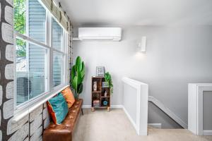 a living room with a couch and a window at Retro Loft steps from Duke in Durham