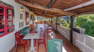a restaurant with tables and chairs on a patio at Casa Rural del General Albelda in Villasante