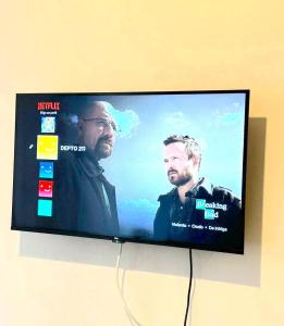 a flat screen tv with two men on it at Central y con todas las comodidades 2 in Santiago