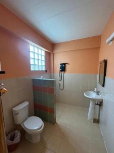 a bathroom with a toilet and a sink at Moondance Cottage Inn in Ko Chang