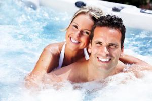 a man and a woman in a hot tub at Aberdunant Hall in Porthmadog