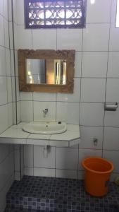 a bathroom with a sink and a mirror at Raditia Homestay in Ubud