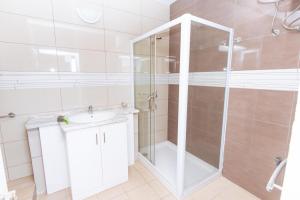 a bathroom with a shower and a sink at Studio Maya Mindelo in Mindelo