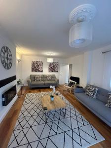 a living room with a couch and a table at BROOK HOUSE 4a in Llangollen