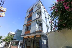 a tall white building with a sign on it at OYO 1064 Phat Tai Hotel And Apartment in Da Nang