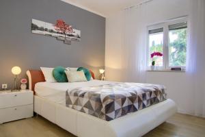 a white bedroom with a bed and a window at Luxury Sunrise Jacuzzi Apts, 50 m from the beach in Kali +49 photos