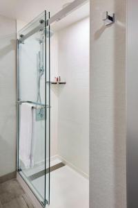 a shower with a glass door in a bathroom at Marriott Columbus Northwest in Dublin