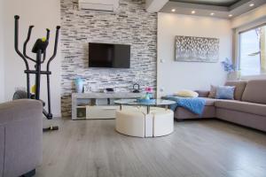 a living room with a couch and a table at Luxury Sunrise Jacuzzi Apts, 50 m from the beach in Kali