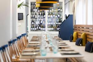 a long table in a room with bottles of wine at HD Parque Cristobal Tenerife in Playa de las Americas