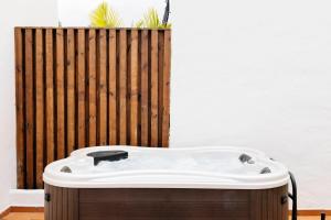 a bath tub in front of a wooden fence at HD Parque Cristobal Tenerife in Playa de las Americas