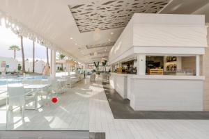 a restaurant with tables and chairs in a building at HD Parque Cristobal Tenerife in Playa de las Americas