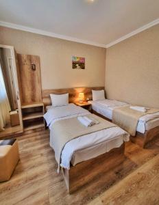 a hotel room with two beds in a room at Sunshine Kazbegi in Stepantsminda