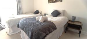 a bedroom with two beds with pillows on them at 2 Bed Crawley Apt - Near Gatwick in Crawley