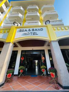 a hotel entrance with a sign that reads sea and sand hotel at Sea and Sand Hotel in Hoi An