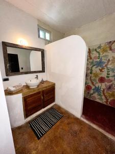 a bathroom with a sink and a mirror at Casa Ixtzá in Nimá