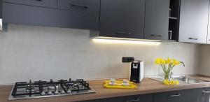 a kitchen with a stove and a counter top at RIO HOME - CHECK IN H 24 in Como