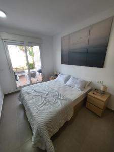 a bedroom with a large bed and a large window at Golf Las Terrazas de La Torre LRVDM House in Roldán
