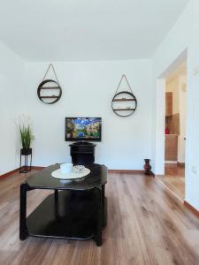a living room with a table and a tv at Apartment Libar with Terrace and private Parking in Mostar