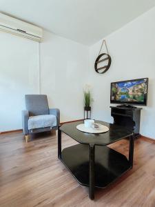 a living room with a coffee table and a tv at Apartment Libar with Terrace and private Parking in Mostar
