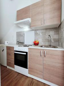 a kitchen with a sink and a stove at Apartment Libar with Terrace and private Parking in Mostar