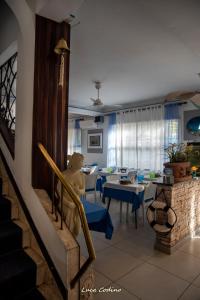 a living room with blue chairs and a table at Albergo La Marinella in Varazze