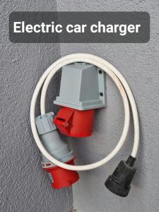 a electric car charger is attached to a hose at Apartman ŠafraM in Ðurmanec