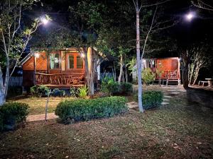 a house with a porch at night with lights at Baan rabiang Pai บ้านระเบียงปาย in Pai +12 photos