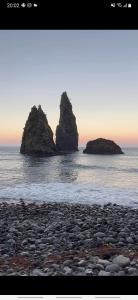 two large rocks in the water on a beach at Casa vicente in Santa Cruz das Flores