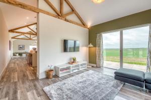 a living room with a couch and a tv at Downs in Blewbury