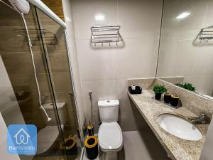 a bathroom with a toilet and a sink and a shower at Studio na Av. Oceânica House Barra in Salvador