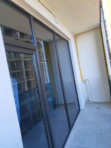 a glass door of a building with a balcony at Almare Batumi in Batumi