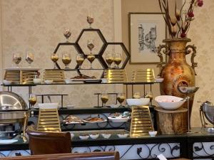 a buffet with plates of food on a table at Arena By Trend in Amman